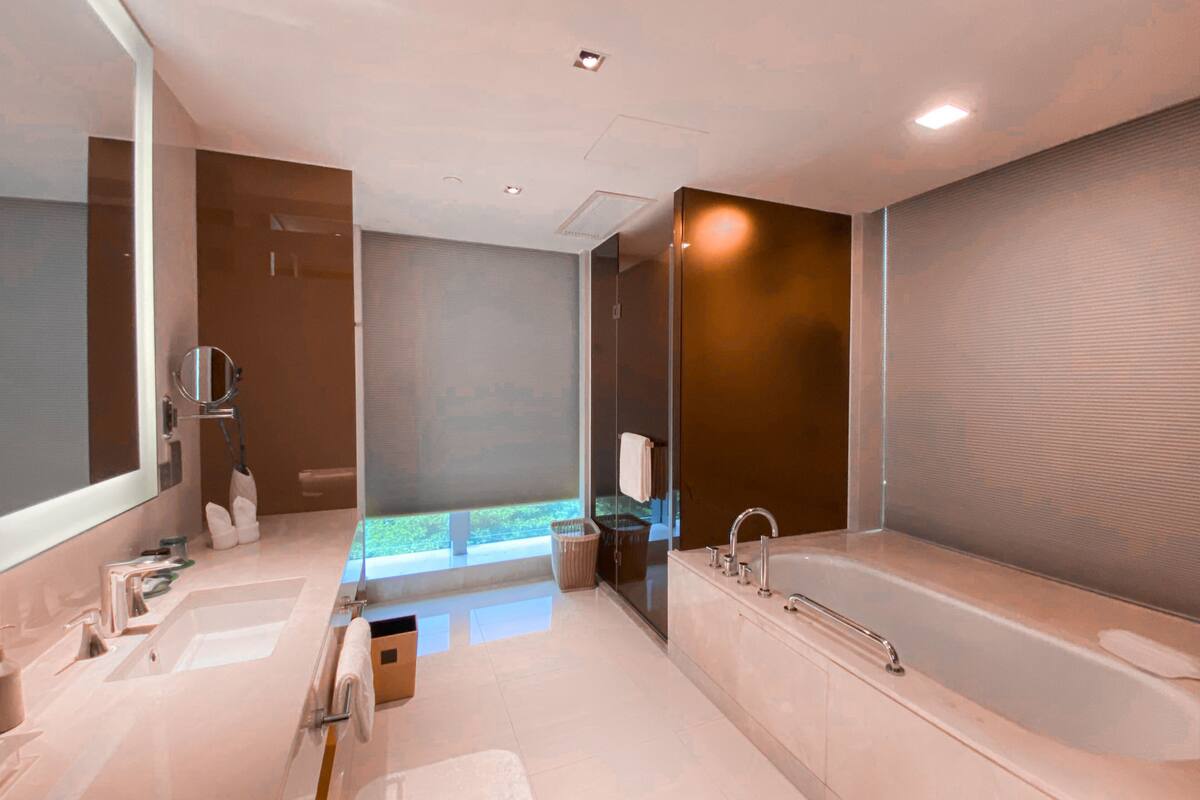 basic suite | bathroom | rainfall showerhead, hair dryer, slippers, towels