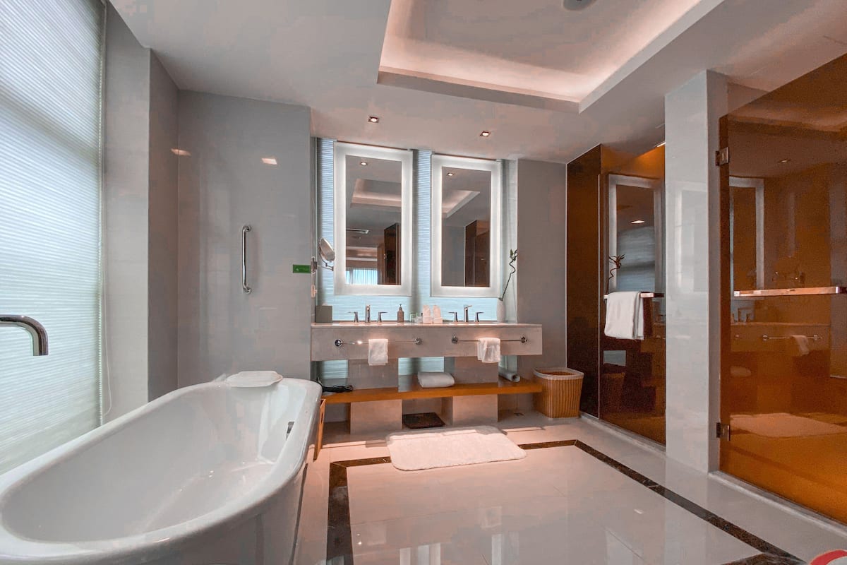 superior suite | bathroom | rainfall showerhead, hair dryer, slippers, towels