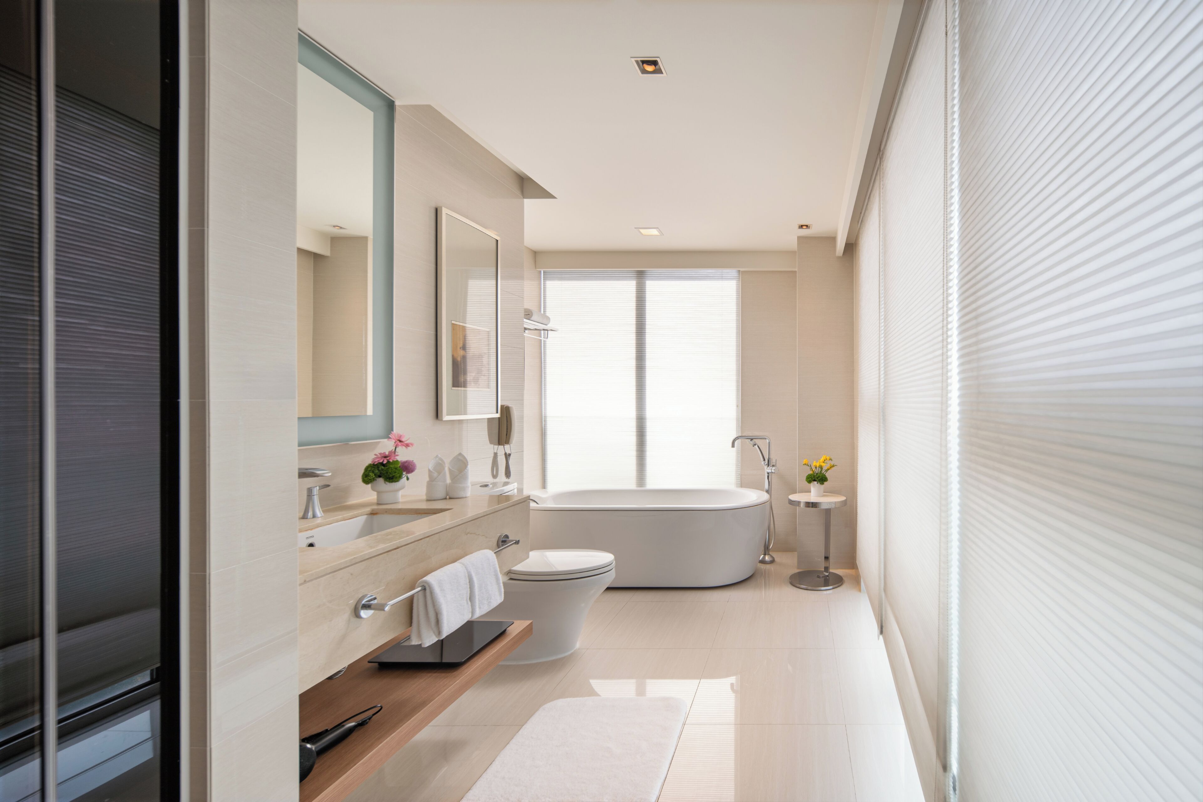 A modern bathroom with a bathtub, toilet, and sink.