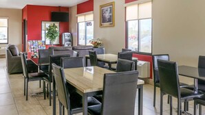 A restaurant interior with booths, tables, and chairs. - Econo Lodge Shorewood (Joliet)