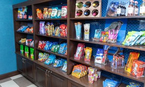 A snack display with various packaged foods and beverages. - Hampton Inn & Suites Williamsport-Faxon Exit (Williamsport)