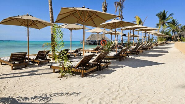 Private beach, white sand, sun loungers, beach umbrellas