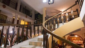 A spiral staircase with a railing, leading to an upper floor. - Ideal Villa Hotel (Port-au-Prince)