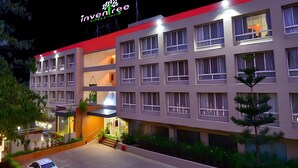 A multi-story hotel with a red roof and a sign reading "Invenree." - Inventree Hotel, Hinjewadi (Paud)