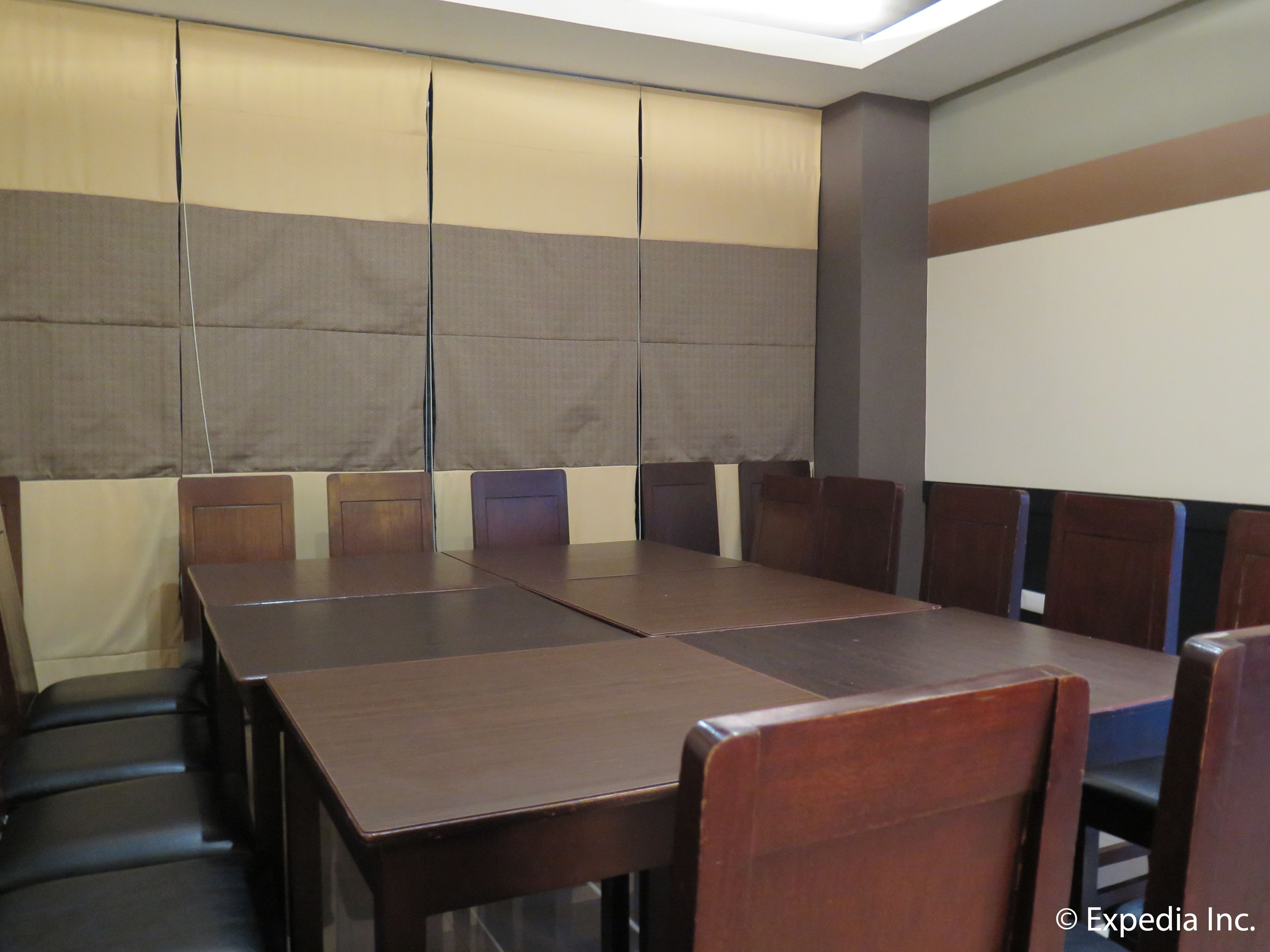 A conference room with a long table and multiple chairs.