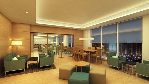A modern hotel lobby with green seating, a wooden floor, and large windows offering a city view. - Fairfield by Marriott Pune Kharadi (Pune)