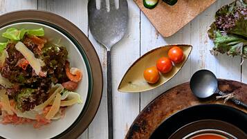 A table with various food items including sandwiches, salad, and soup.