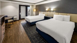A hotel room with two beds, a desk, and a view of the outdoors. - Best Western Freeport Inn (Freeport)