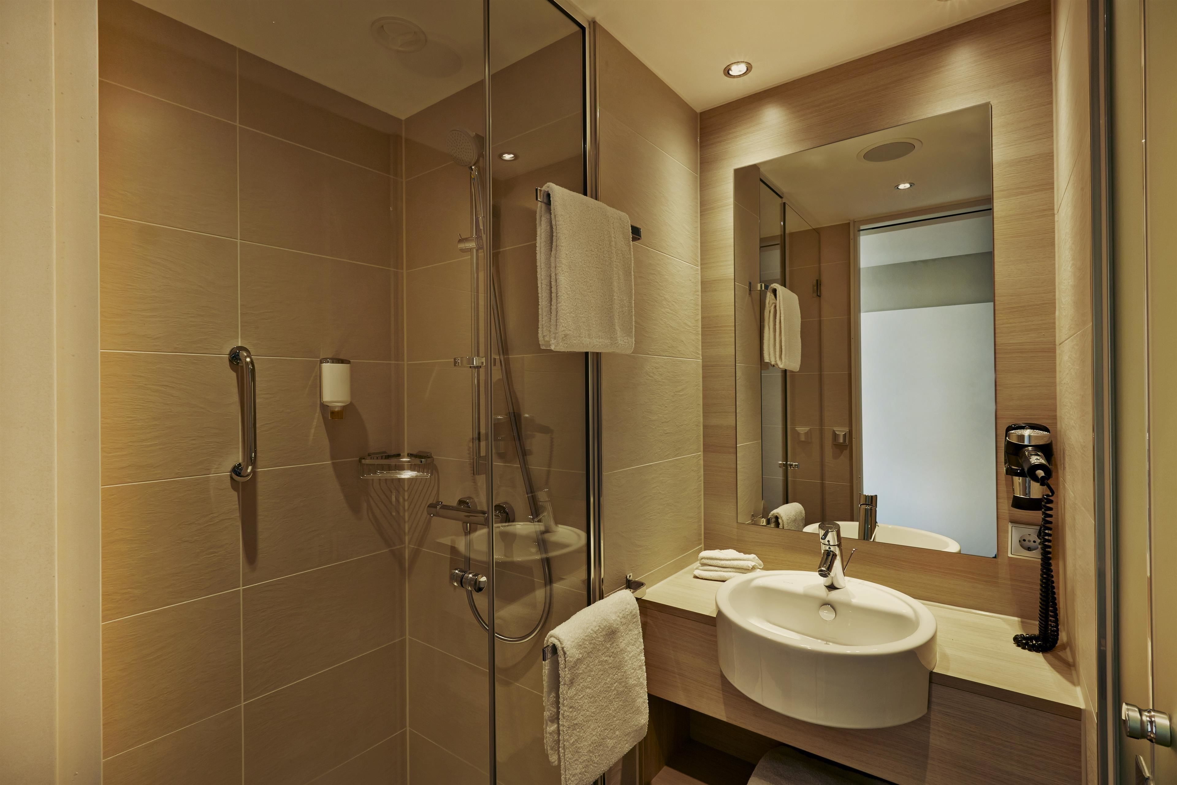 shower, rainfall showerhead, hair dryer, towels