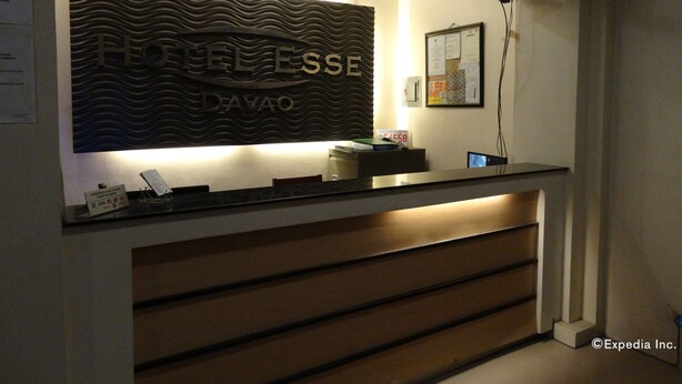 A hotel reception desk with a modern design, featuring a large illuminated sign that reads "HOTEL ESSA DE AVAO". - Hotel Esse Davao (Davao)