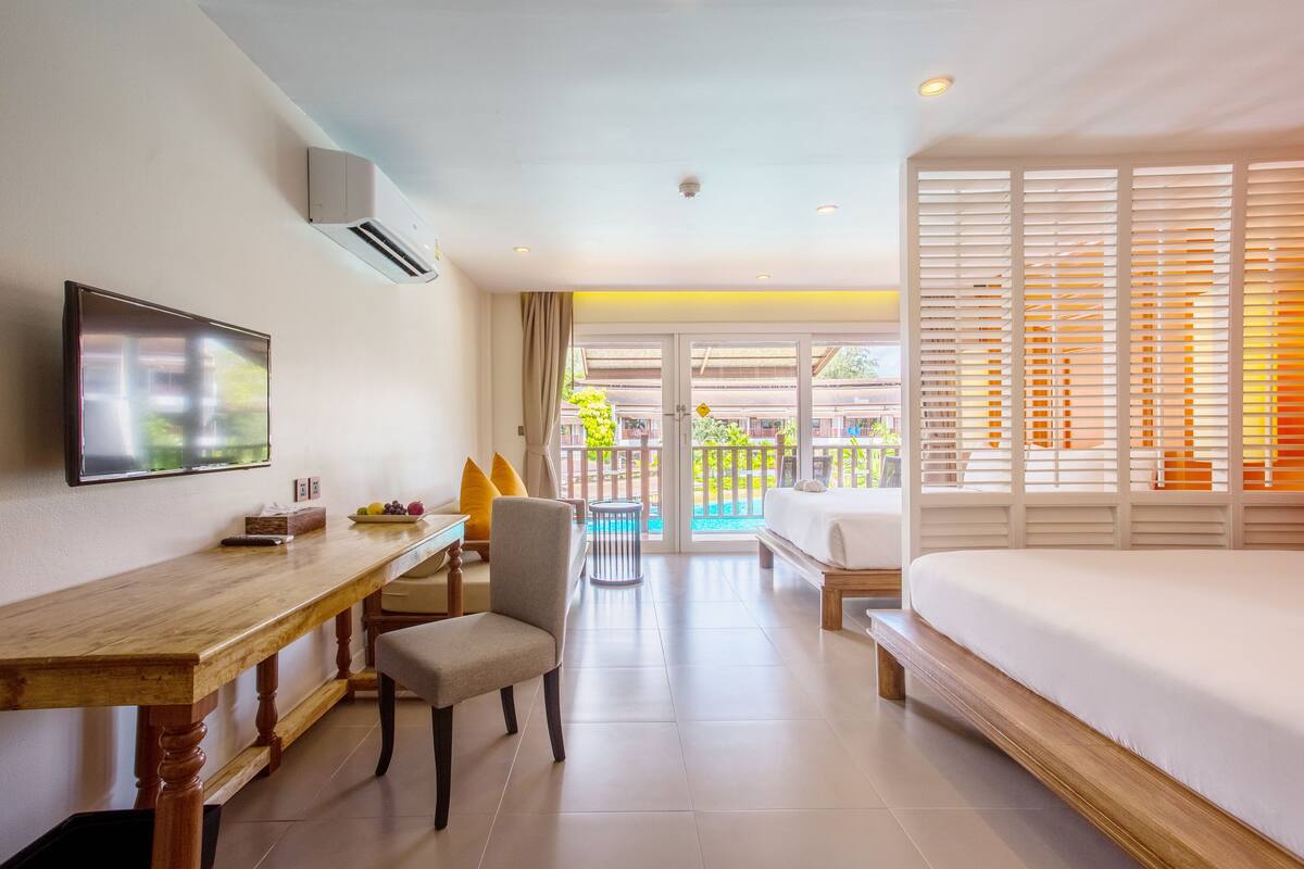 grand deluxe pool view | 1 bedroom, in-room safe, laptop workspace, iron/ironing board