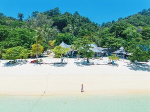 A beach resort with thatched-roof huts, a sandy beach, and lush greenery. - Mayalay Resort-Green Hotel (Ko Lanta)