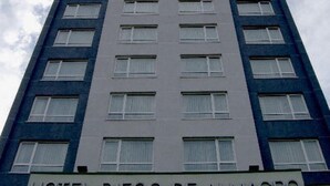 A tall hotel building with the name "HOTEL DIEGO DE ALMAGRO" at the bottom.