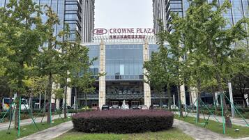 A modern building with the sign "Crowne Plaza" indicating a hotel.
