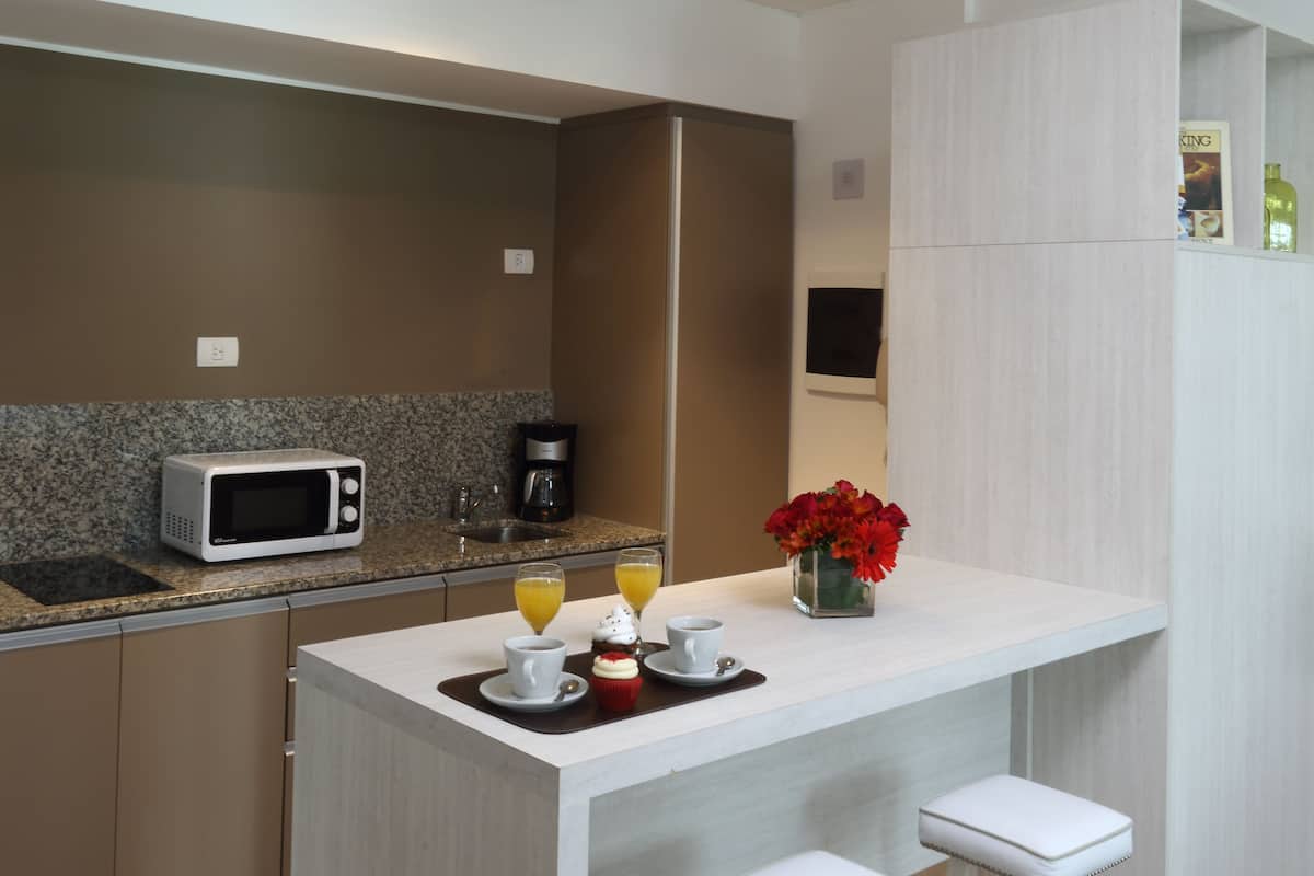 full-sized fridge, microwave, coffee/tea maker, cookware/dishes/utensils