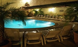 A pool area with lounge chairs and a tropical setting. - Hotel Argento (Cuernavaca)