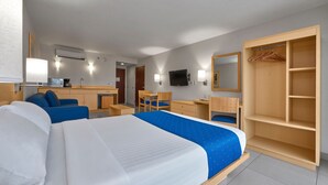 A hotel room with a large bed, a desk, a chair, a wardrobe, and a television. - City Express by Marriott Xalapa (Xalapa)