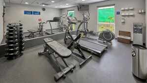 A gym with various exercise equipment including dumbbells, treadmills, and weight machines. - City Express by Marriott Xalapa (Xalapa)