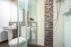 A bathroom with a glass shower enclosure, a white sink, and a toilet. - 624 Phi Phi Palms Residence (Ko Phi Phi)