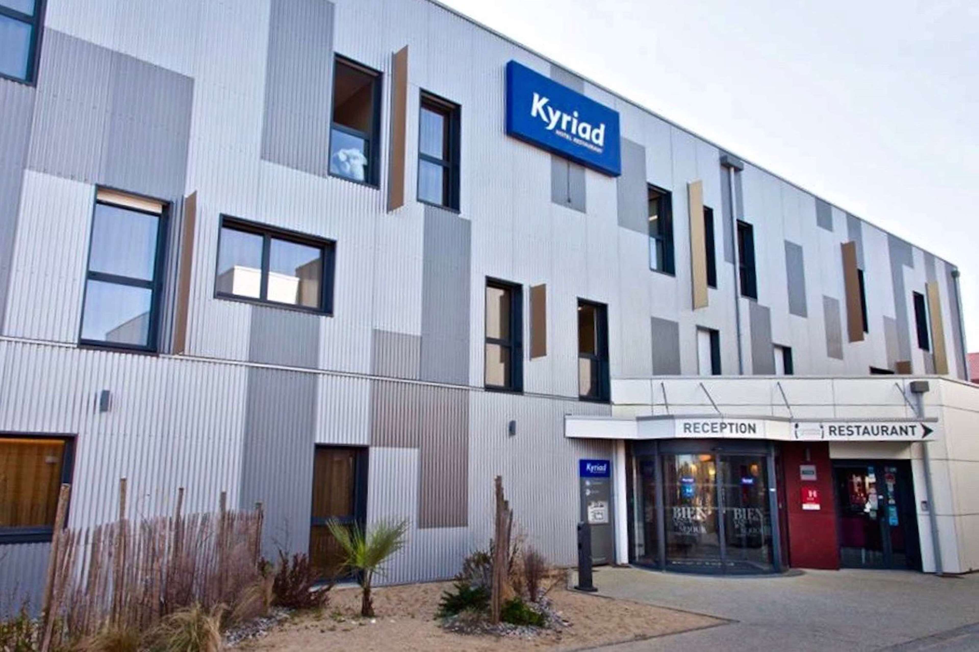 A modern hotel building with a reception and restaurant area.