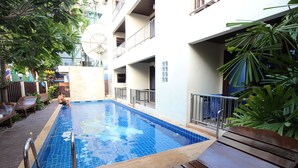 A swimming pool with a 1.2m depth, surrounded by wooden deck and metal railings. - JJ Residence (Ko Phi Phi)