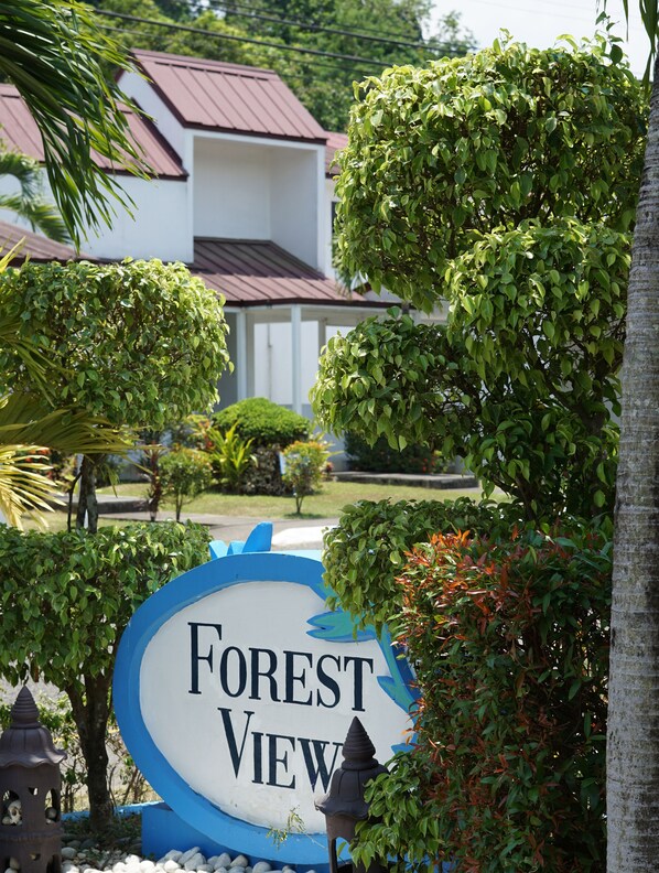 A sign for "Forest View" with a view of a building and surrounding greenery. - Forest View Leisure Residences (Morong)