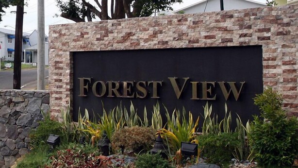 A sign for "Forest View" with a stone and brick facade, surrounded by various plants and shrubs. - Forest View Leisure Residences (Morong)