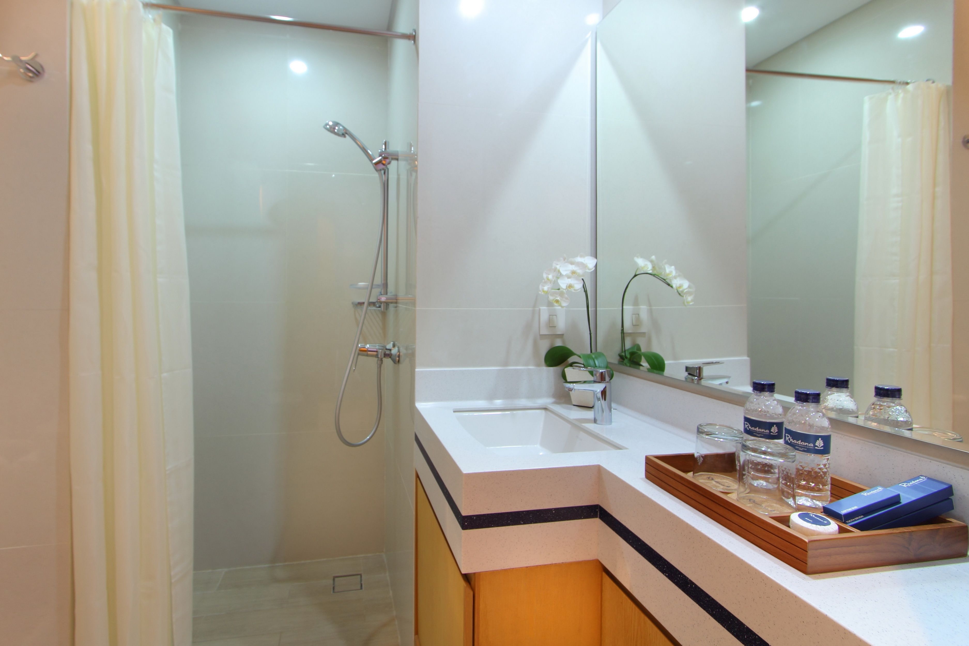 shower, hair dryer, slippers, towels