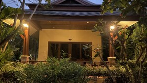 A building with a covered entrance, surrounded by lush greenery. - Grand Manita Beach Resort (Koh Samui)