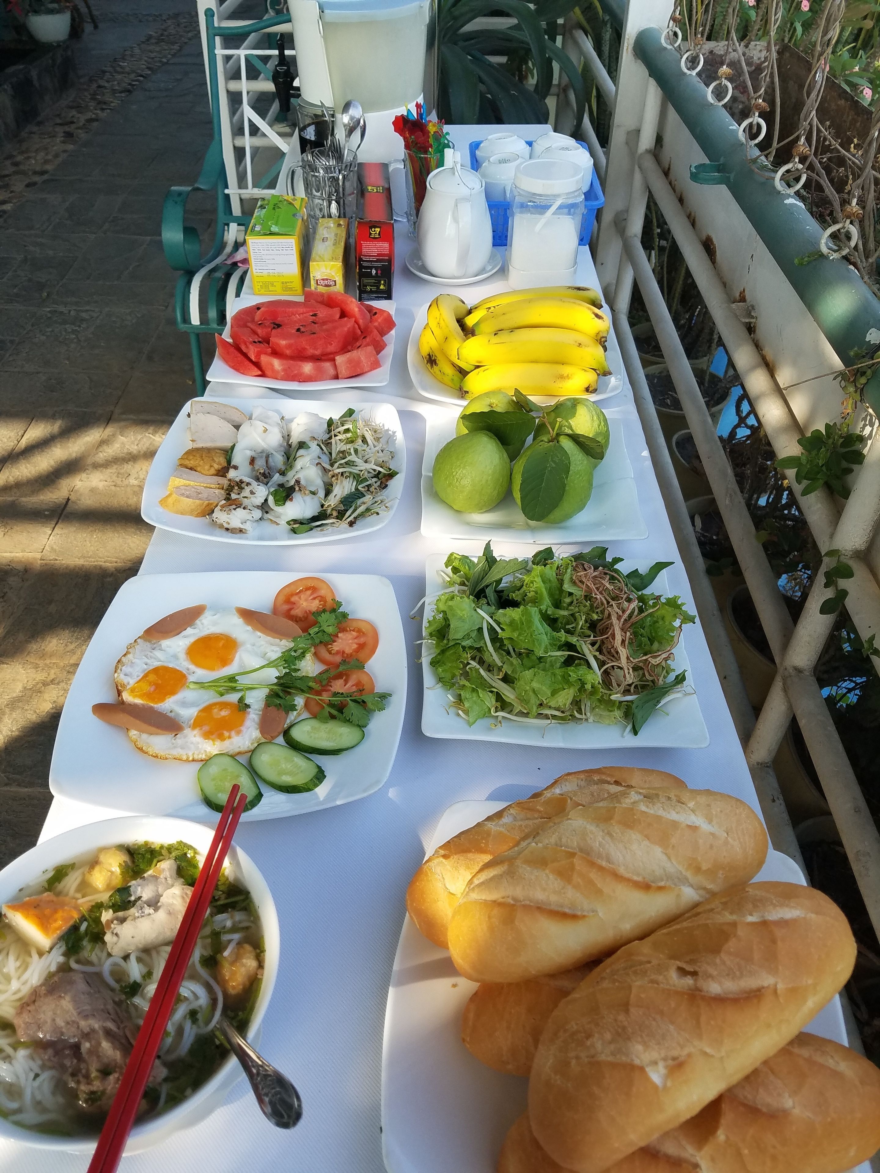 A table with various dishes including eggs, salad, and bread.