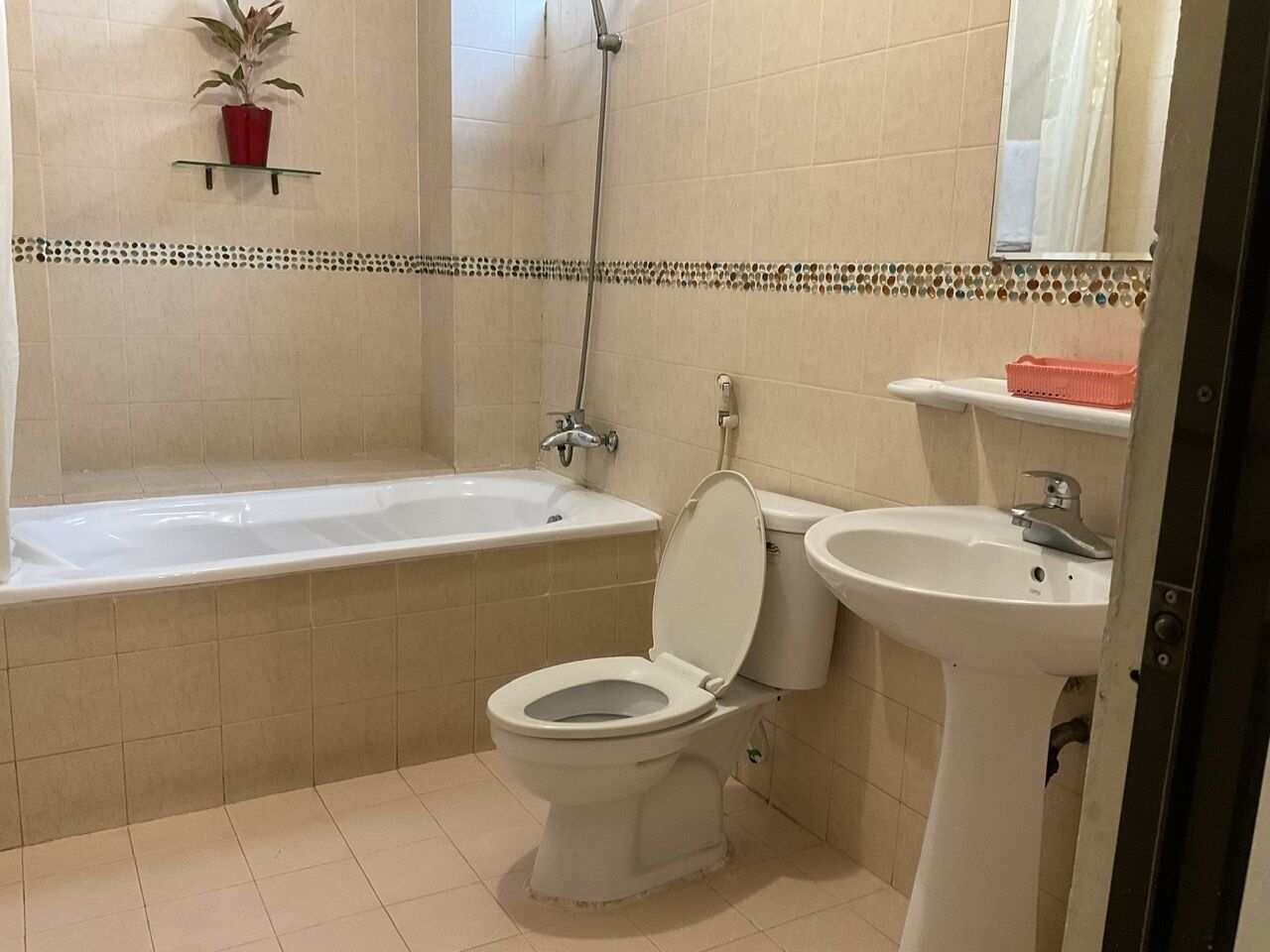 A bathroom with a bathtub, toilet, and sink.