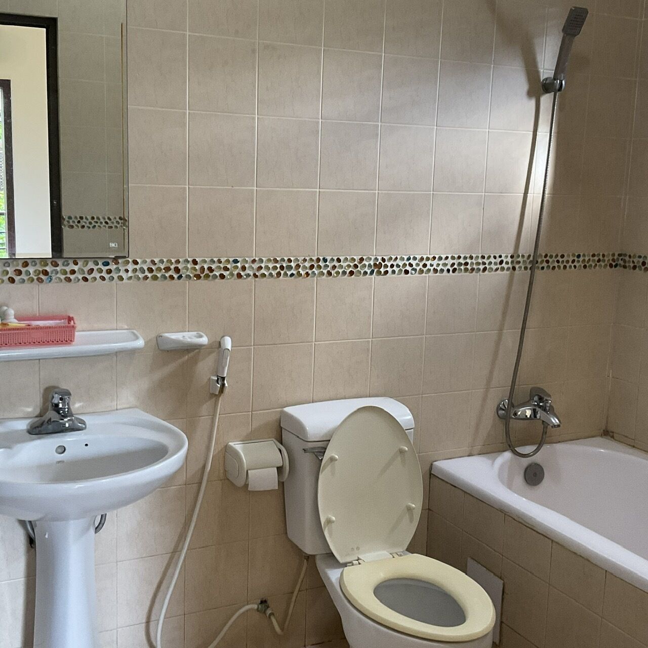A bathroom with a sink, toilet, and bathtub.