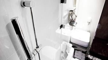 A bathroom with a toilet, a sink, and a mirror.