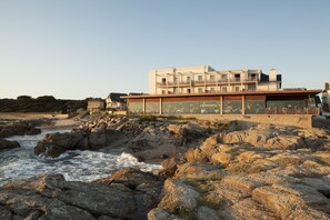 A coastal building with multiple balconies overlooking the sea.