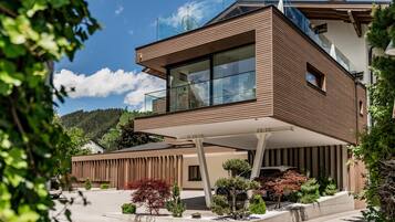 Situated in a scenic area, this building features a sleek design with large glass windows and a landscaped garden.