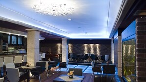 A modern lounge area with seating and a bar.