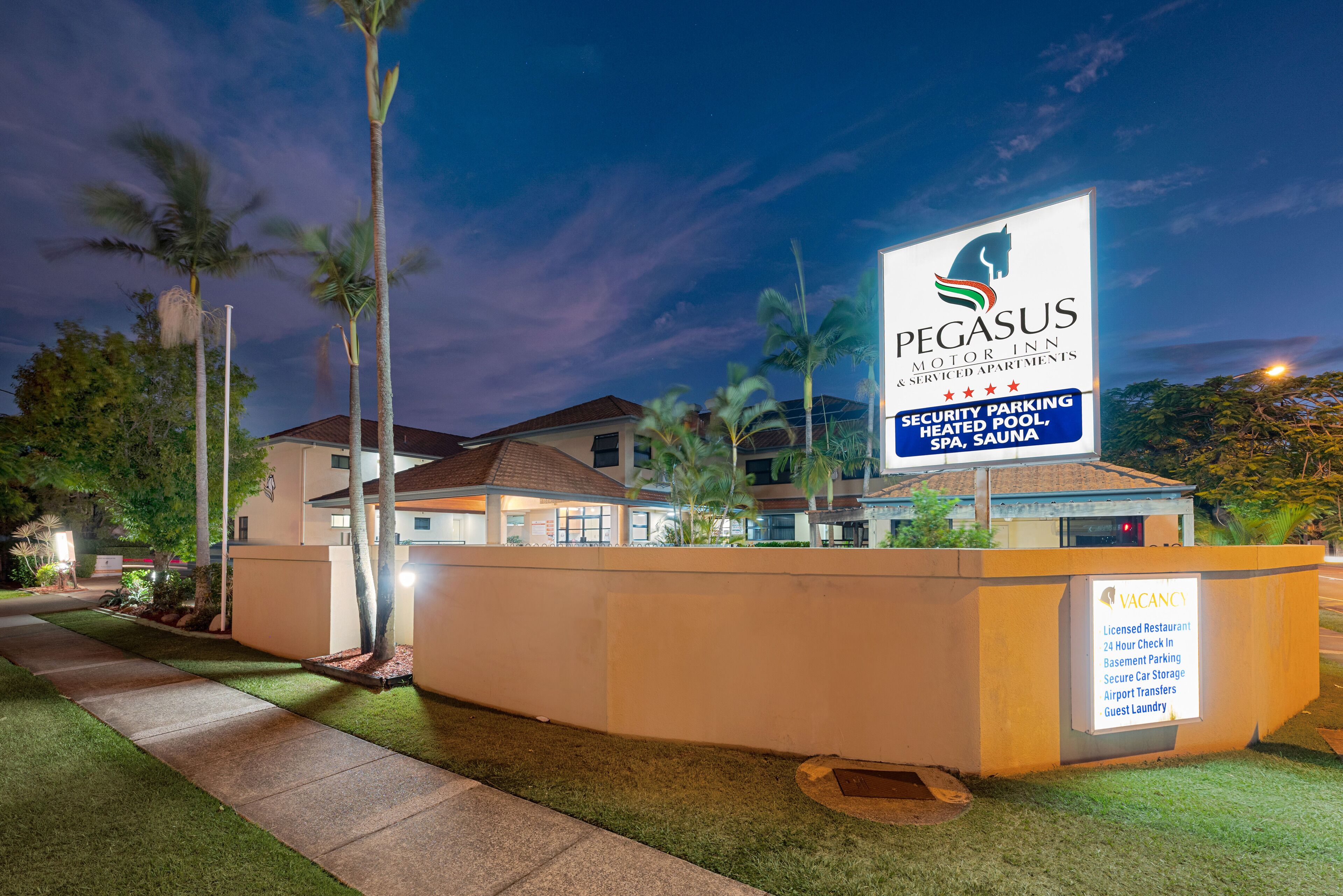 A Pegasus Motor Inn signboard with amenities like security parking, heated pool, SPA, and sauna.