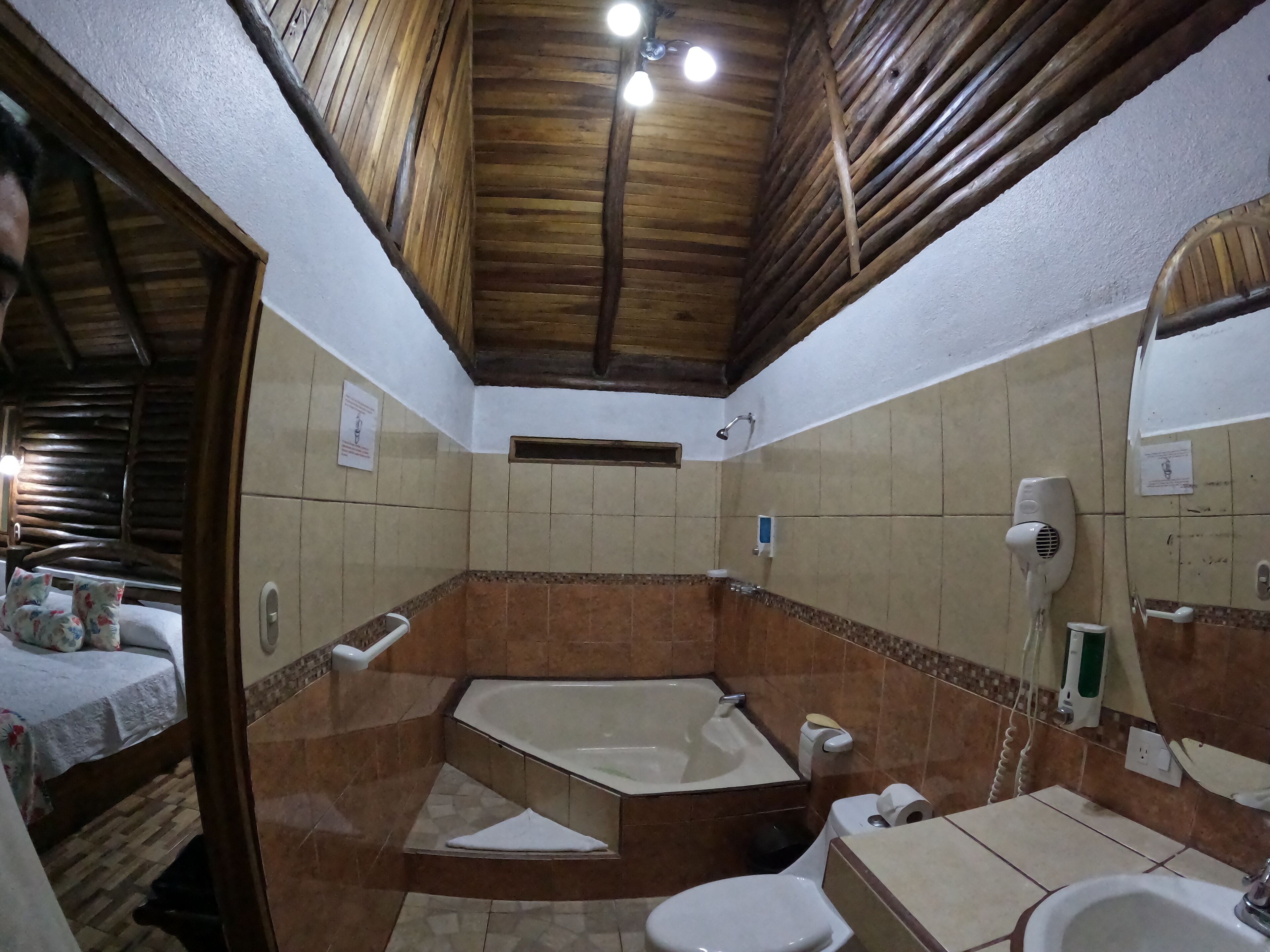 A bathroom with a bathtub, toilet, and sink.