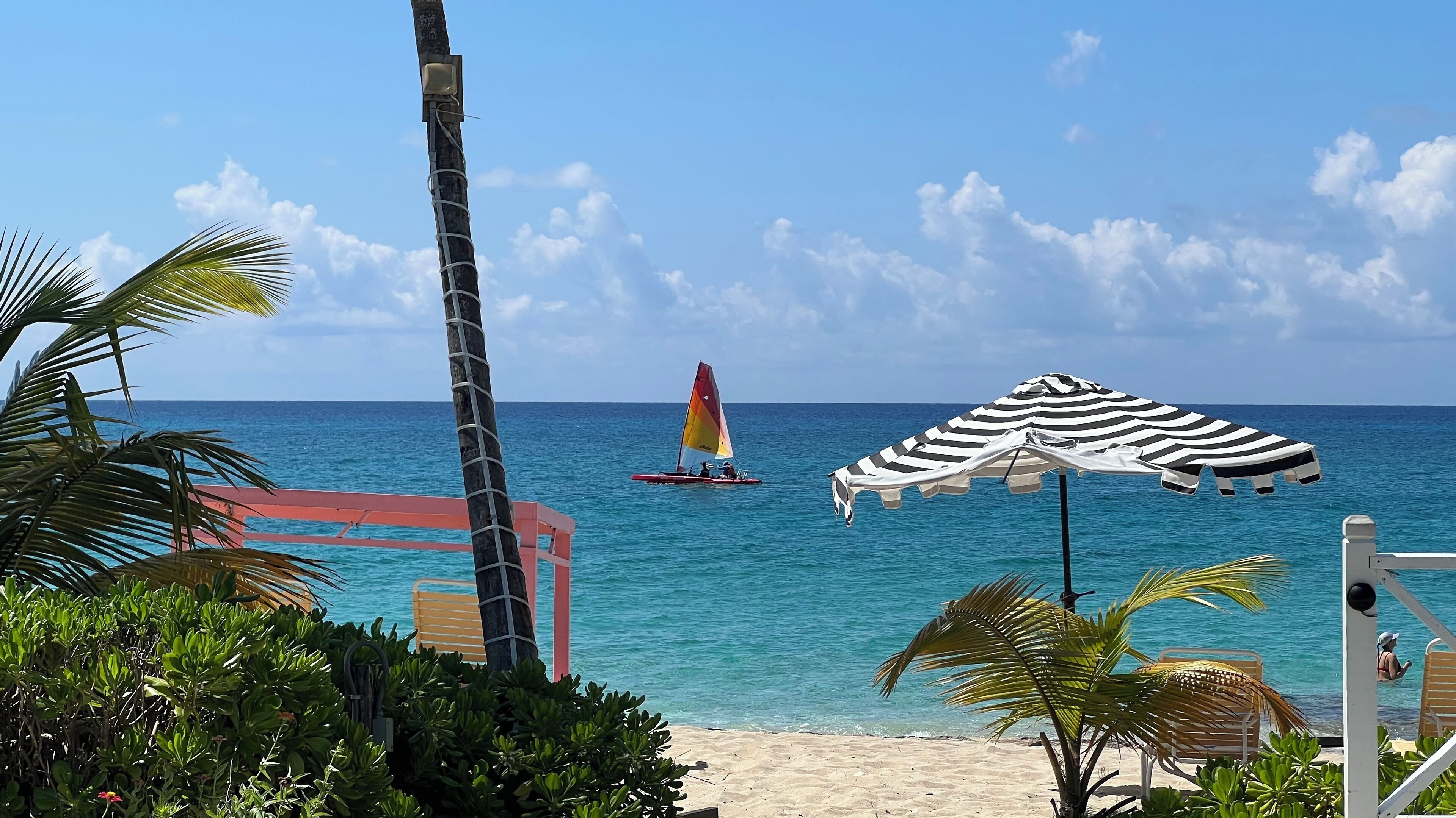On the beach, white sand, sun-loungers, beach umbrellas