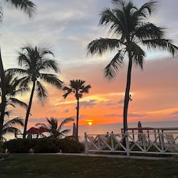 On the beach, white sand, sun loungers, beach umbrellas
