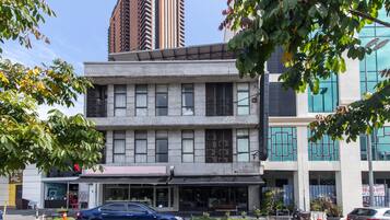 A multi-story building with a modern architectural style, featuring large windows and a flat roof.