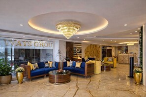 A luxurious lobby with a grand chandelier, seating areas, and a reception desk. - Hotel Ramhan Palace (New Delhi)