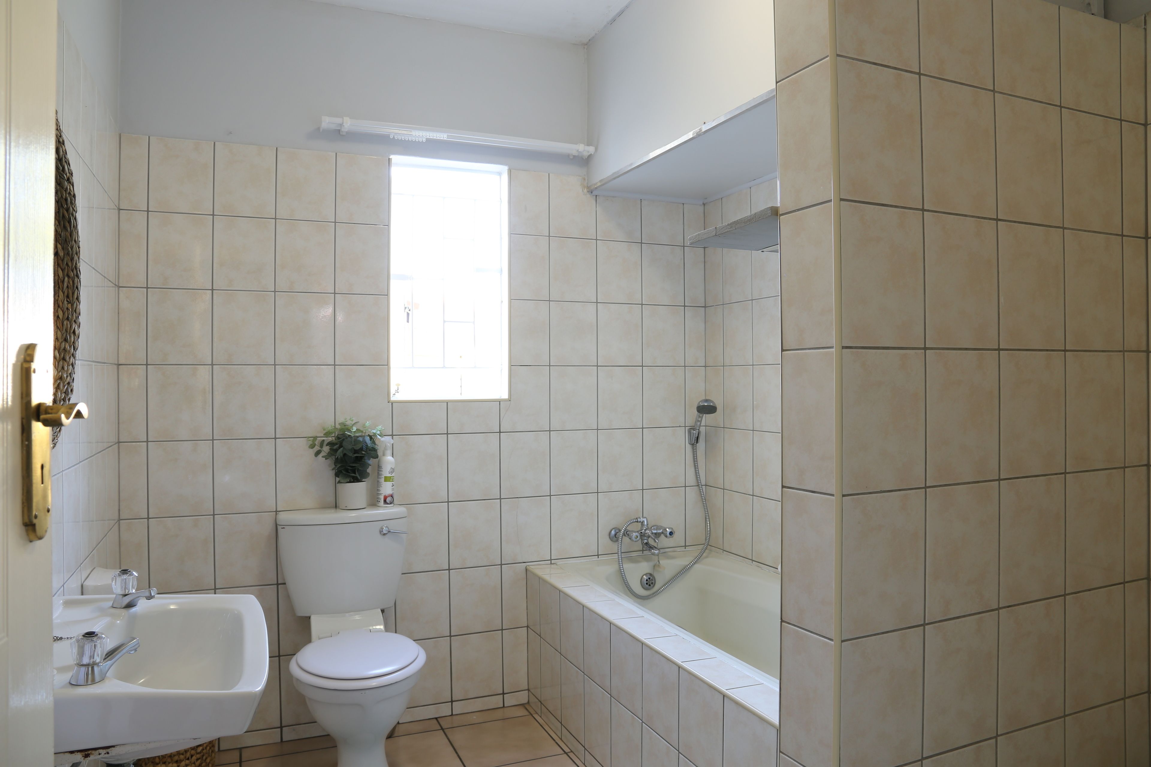 A bathroom with a toilet, sink, bathtub, and shower.