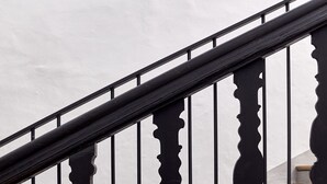 A staircase with black balusters and wooden steps. - Walther von der Vogelweide (Chiusa)