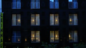 A building with multiple windows, some with metal railings.