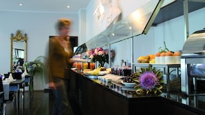 A buffet area with a variety of food items and a decorative statue.