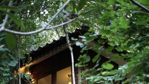 A wooden staircase leading to a second-story balcony with a hanging light fixture. - Viva Chiang Mai (Chiang Mai)
