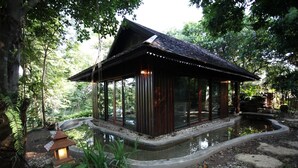 A traditional wooden structure with a curved pond, surrounded by lush greenery and stone pathways. - Viva Chiang Mai (Chiang Mai)