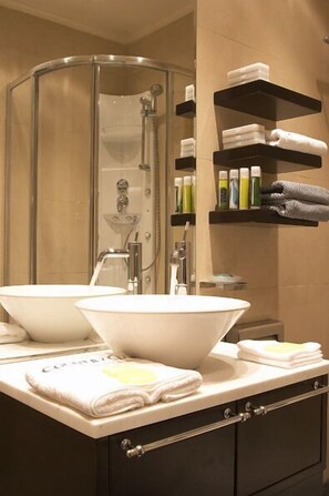 Shower, designer toiletries, hair dryer, slippers