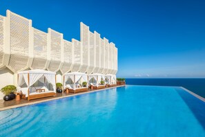 A poolside area with a series of white canopies and wooden loungers. - The Westin Sanya Haitang Bay Resort (Sanya)